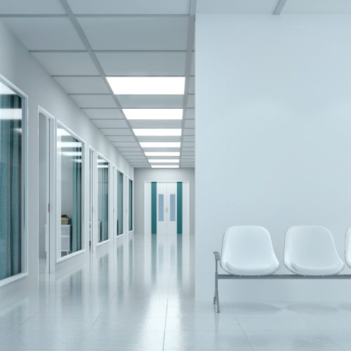 Empty corridor in modern hospital with waiting area and hospital bed in rooms.3d rendering